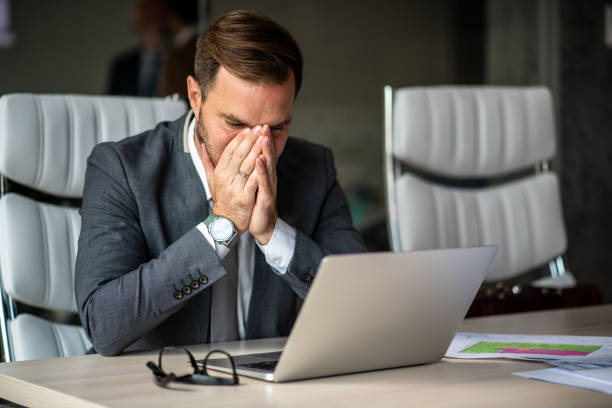 istock Junior businessman tired of work, trying to focus on paperwork. 1291091561