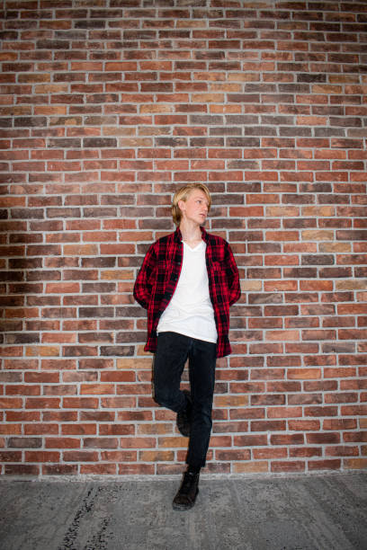 istock Young teenager leaning against a brick wall 1291094753