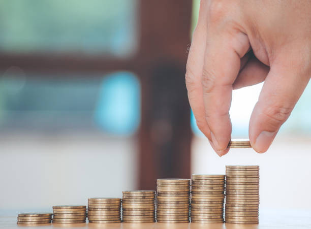 istock Hand are stacking with coins to save the financial stability for the future. Concept for loan, property ladder, financial, mortgage, real estate investment, taxes and bonus. 1291094875