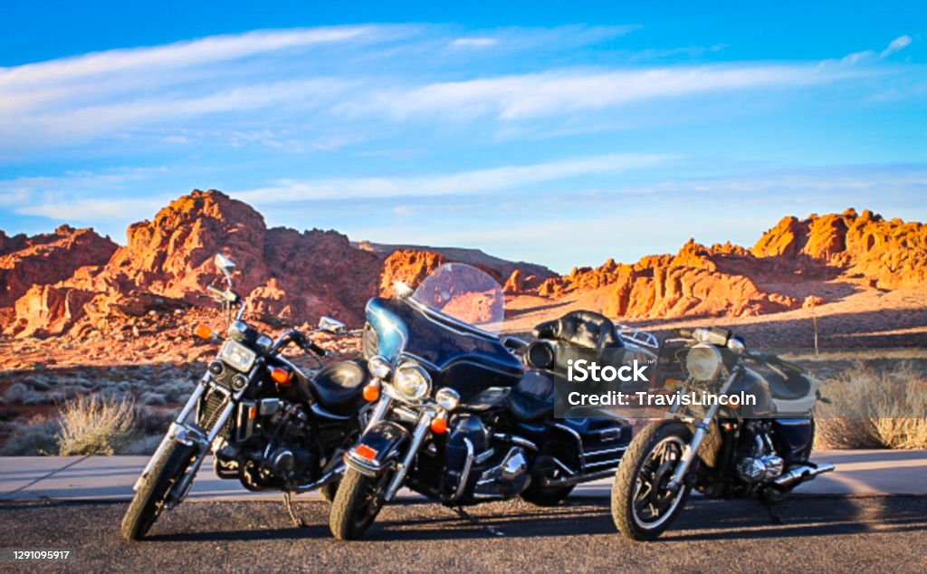 Trio of Motorcycles in The Valley of Fire Three vintage motorcycles parked in front of the red rocks of Nevada's Valley of Fire. Motorcycle Stock Photo