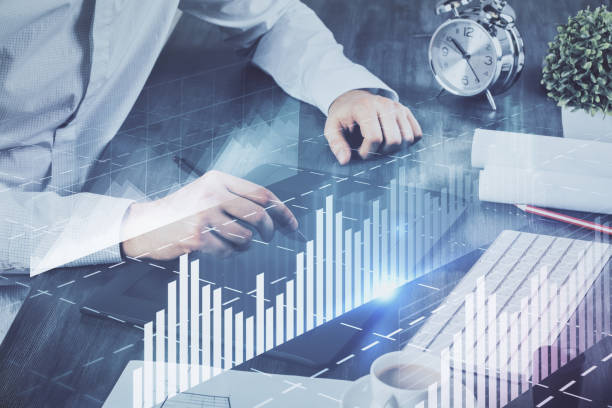 istock Double exposure of man's hands holding and using a phone and financial graph drawing. Analysis concept. 1291096059