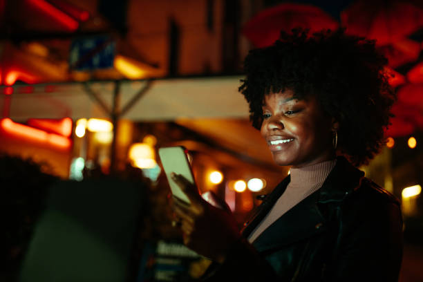 istock Female outdoors at night, checking social media 1291099479