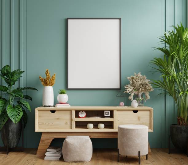 istock Mock up poster frame on cabinet in interior,Dark green wall. 1291100462