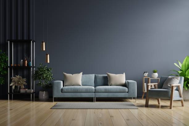 istock The interior has a sofa and armchair on empty dark wall background. 1291100465