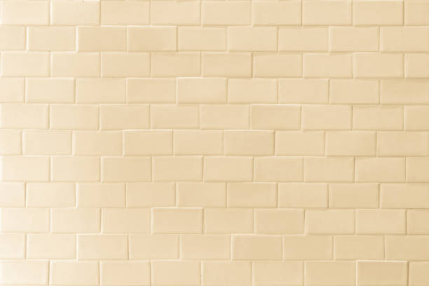 istock Porcelain tile texture patterned wall background light yellow cream beige color 1291101262