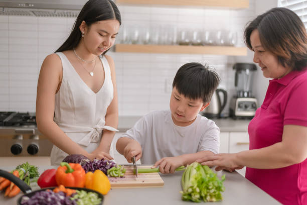 istock Young boy cooking with his mom and sister 1291101286
