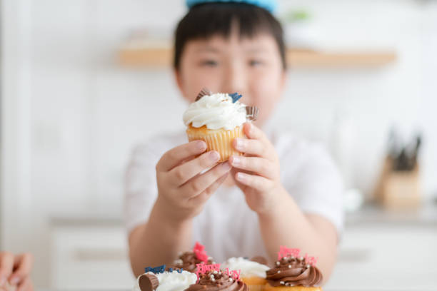 istock Boy holding birthday cupcake 1291101291