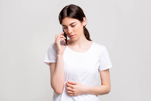 Phone call. Distance communication. Relaxed woman having conversation isolated on white copy space. Information technology. Casual lifestyle.