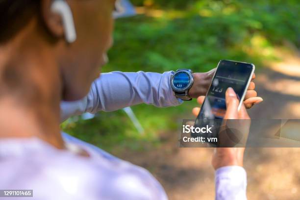 Over Shoulder View On Woman Using Tracker Software Stock Photo - Download Image Now - Fitness Tracker, Smart Watch, Wearable Computer