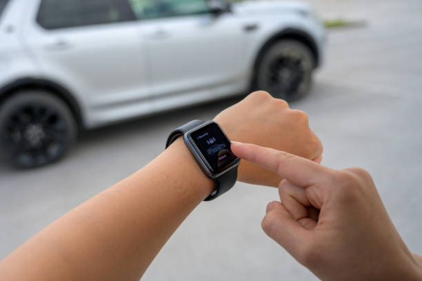 istock Woman unlocking car by software in smartwatch 1291101468
