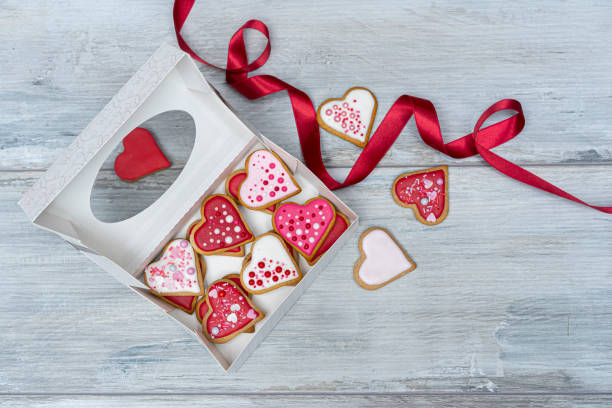 Heart shape cookies in a white box and red ribbon