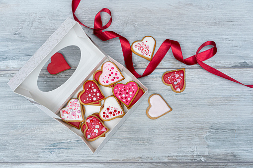 Heart shape cookies in a white box and red ribbon