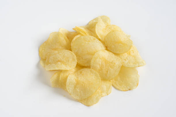 istock Stacked of potatoes chips on white table. 1291102410
