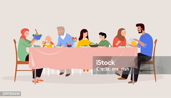 istock Festive dinner family scene. Children, parents and grandparents sitting at a dinner table, eating together. 1291102510