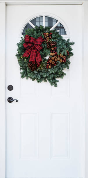 istock White Door with Evergreen Holiday Wreath 1291102660