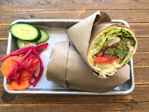 Healthy, Vegan Falafel Wrap Sandwich with Side Salad on Table