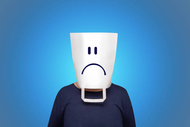 Blue monday concept. The most depressing day of the year. White pocket with sad face on head. Blue background. Negative qualities and feelings of person. Tired office staff.
