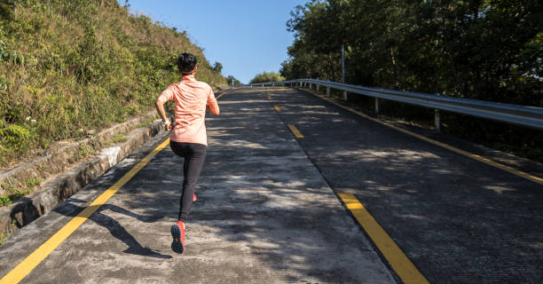 istock Woman runner running on mountain top on winter day 1291112361