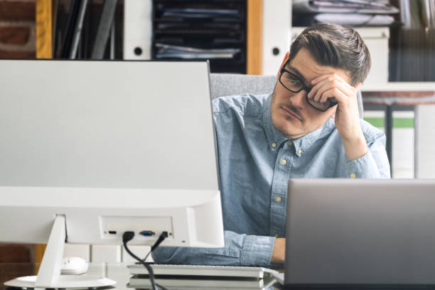 istock Bored Unhappy Man Watching In Online Virtual Lecture 1291113229