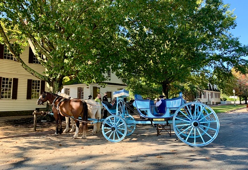 Williamsburg, VA, USA - September 30, 2020: Tourists are waiting for horse drawn carriage ride in Williamsburg, Virginia, USA.