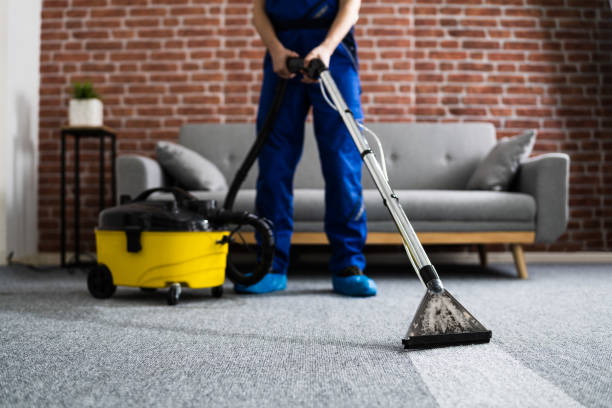 istock Janitor Cleaning Carpet With Vacuum Cleaner 1291113949