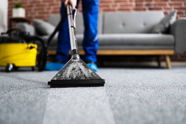 istock Janitor Cleaning Carpet With Vacuum Cleaner 1291113951