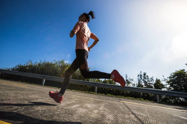 istock Female runner running on mountain top on winter day 1291114053