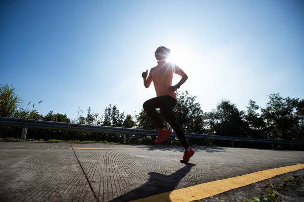 istock Woman runner running on mountain top on winter day 1291114236