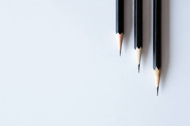 istock back to school concept, black pencil on white table background 1291116750