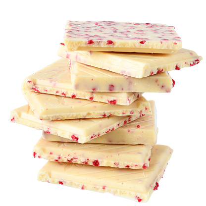Heap white chocolate with strawberry close up isolated on a white background.