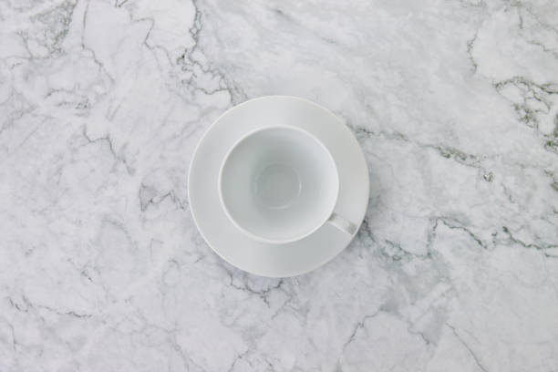 istock Top View White Coffee Cup on Marble Office Desk or Office Table 1291122925