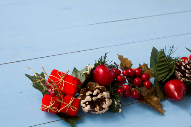 istock Interesting beautiful Christmas ornament decorations on blue colored wooden surface texture with copy space. 1291126058