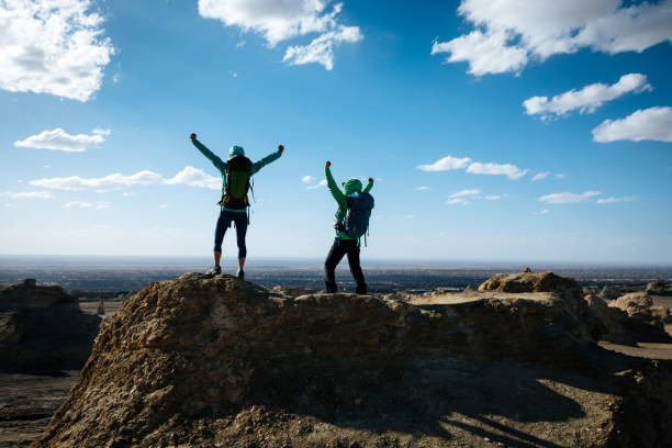 istock Two women backpackers hiking on sand desert 1291127168