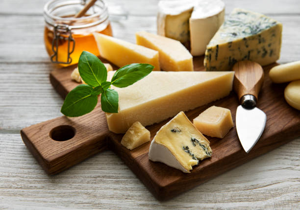 istock Various types of cheese  on a white wooden  background 1291133430