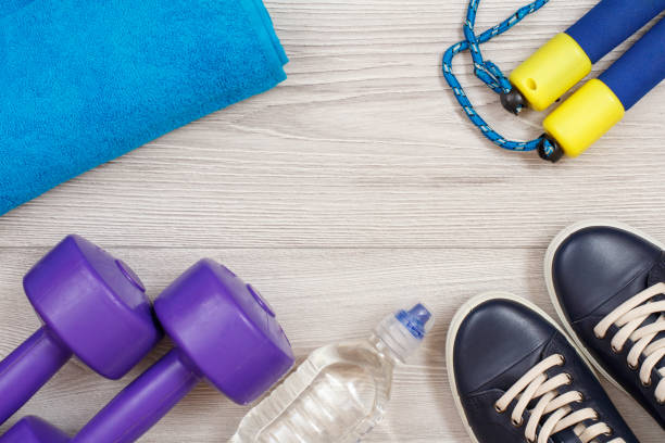 istock Different tools for fitness on floor in room 1291135390