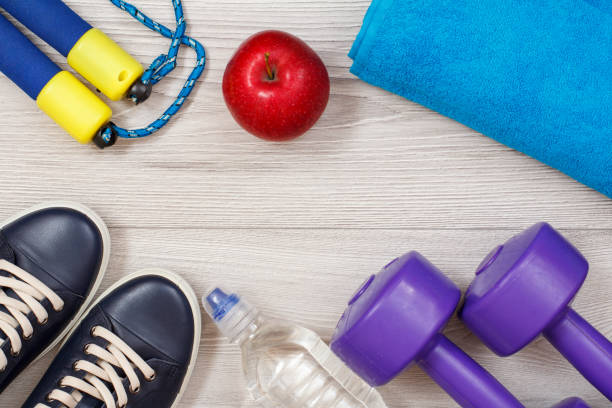 istock Different tools for fitness on floor in room 1291135399