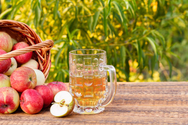 istock Just picked apples in a wicker basket and apple cider in glass goblet 1291136397