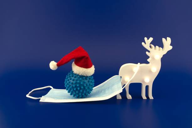 istock Christmas deer scene with coronavirus gift 1291139670