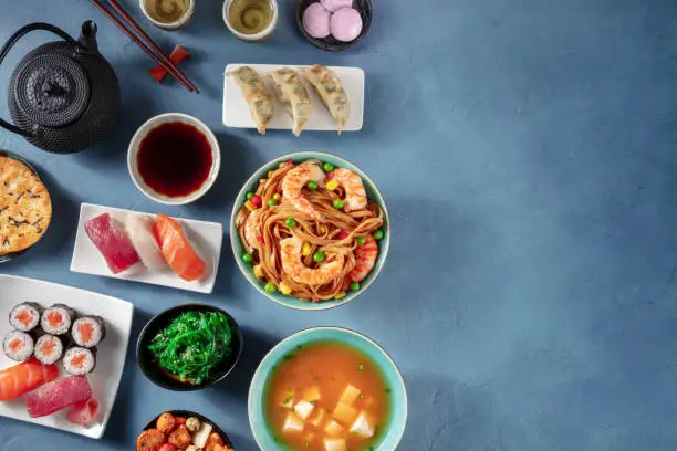 Photo of Japanese food variety with copy space. Various oriental dishes, shot from the top with copy space