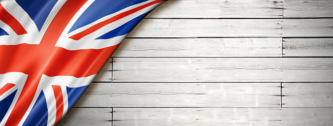 United Kingdom, UK flag on old white wall. Horizontal panoramic banner.