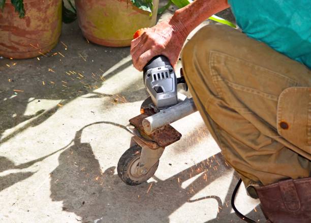 istock Worker with a welding machine fixing a caster wheels, fiery sparks flying around 1291142801