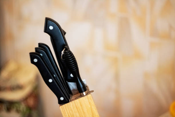 istock Black kitchen knives in the stand close up 1291143799
