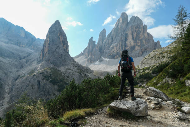 istock Oberbachernspitze - A man with big backpack hiking in high, Italian Dolomites. There are many sharp peaks behind 1291145943