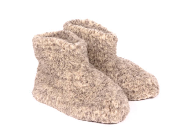 istock Warm woolen indoor slippers, isolated on white 1291145994