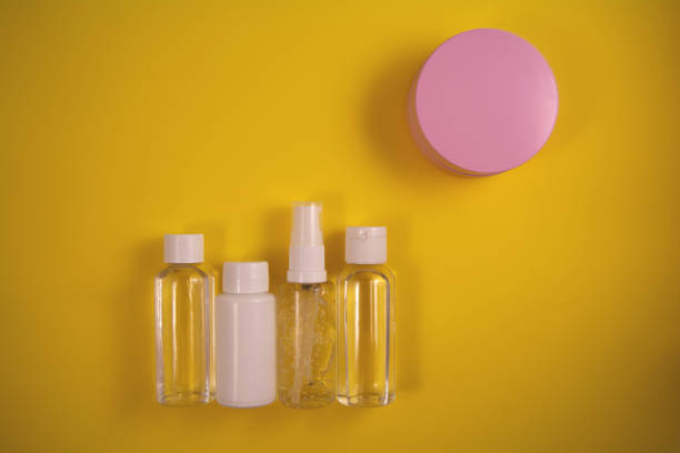 istock Cosmetic containers on yellow background 1291146293