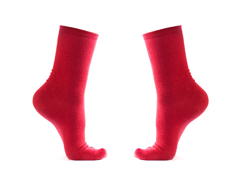 Red socks on the leg. Close up. Isolated on a white background.