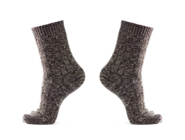 istock Wool socks on the foot. Close up. Isolated on a white background 1291147389
