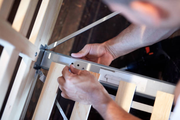 istock Carpenter hobbyist assembling wooden boards at home / garage. 1291148386