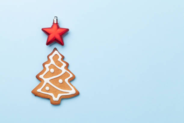 istock Christmas card with fir tree gingerbread cookie 1291148521