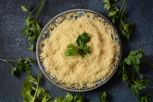 istock Cooked couscous with green parsley in  ceramic plate 1291148713